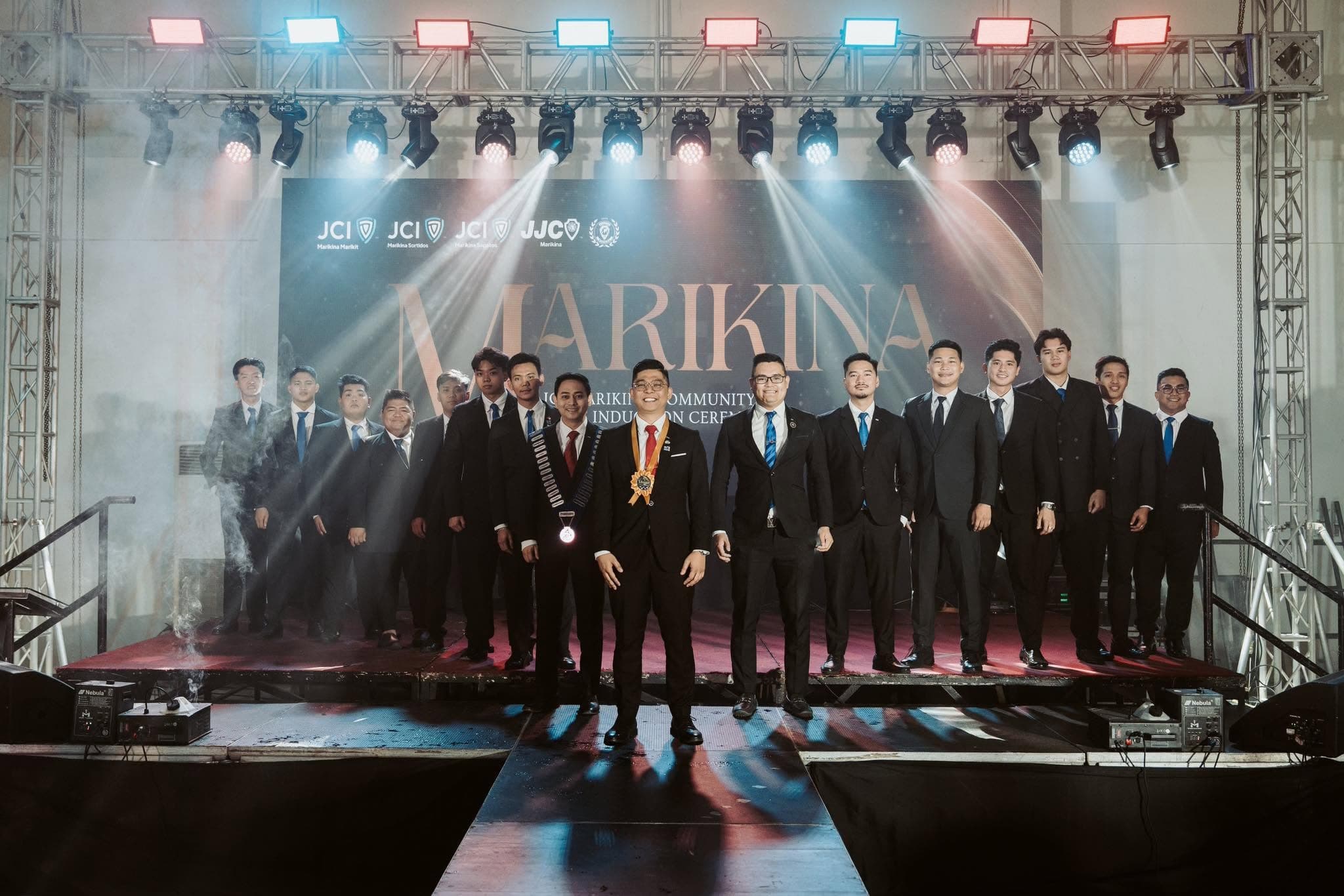 JCI Marikina Sapatos members in formal suits on stage at the Marikina community induction ceremony